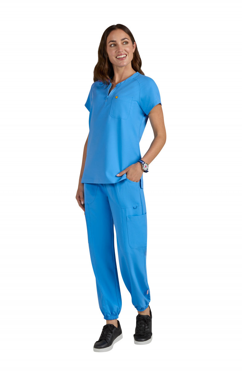 koi | SmileyWorld Ecstatic Women's 1-Pocket Zipper-Neck Scrub Top