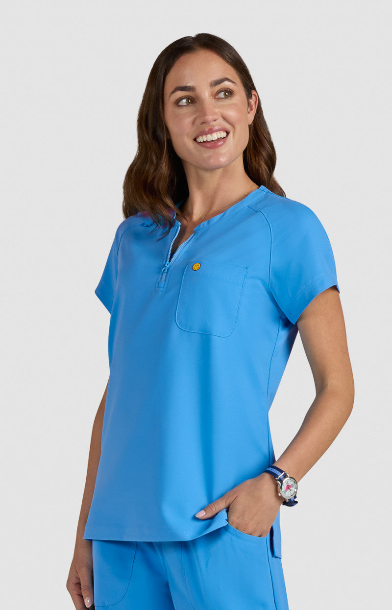 koi | SmileyWorld Ecstatic Women's 1-Pocket Zipper-Neck Scrub Top