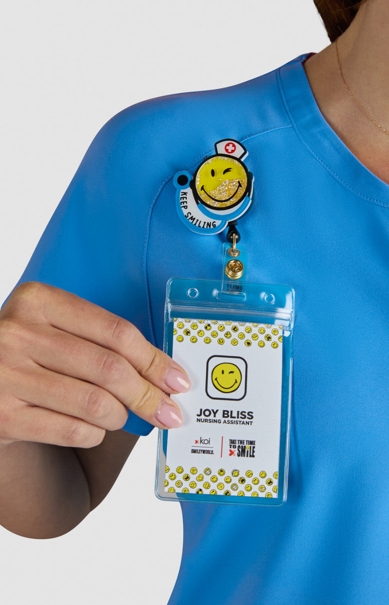 koi | SmileyWorld Ecstatic Women's 1-Pocket Zipper-Neck Scrub Top