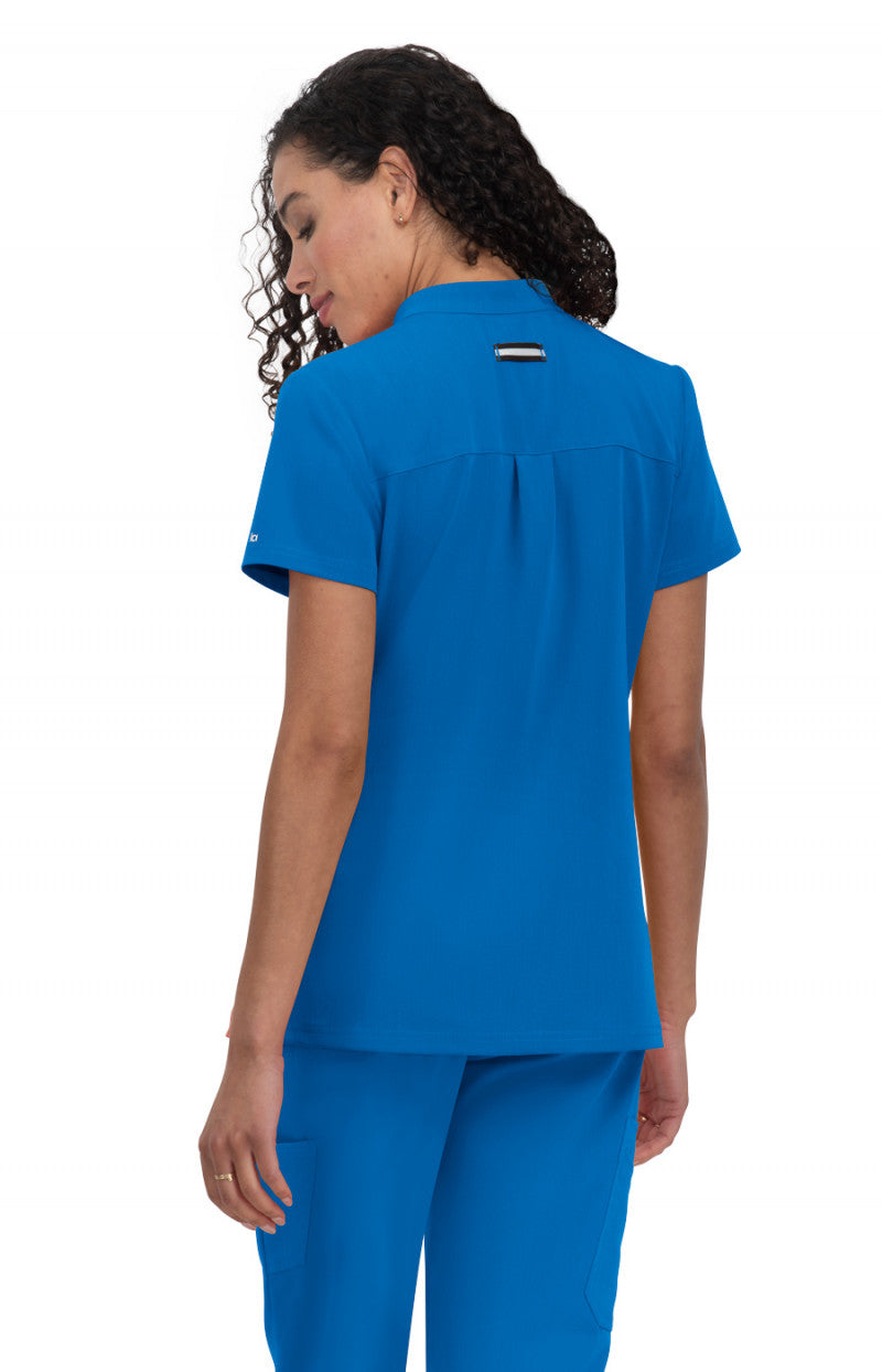 koi Next Gen Driven Women's Top